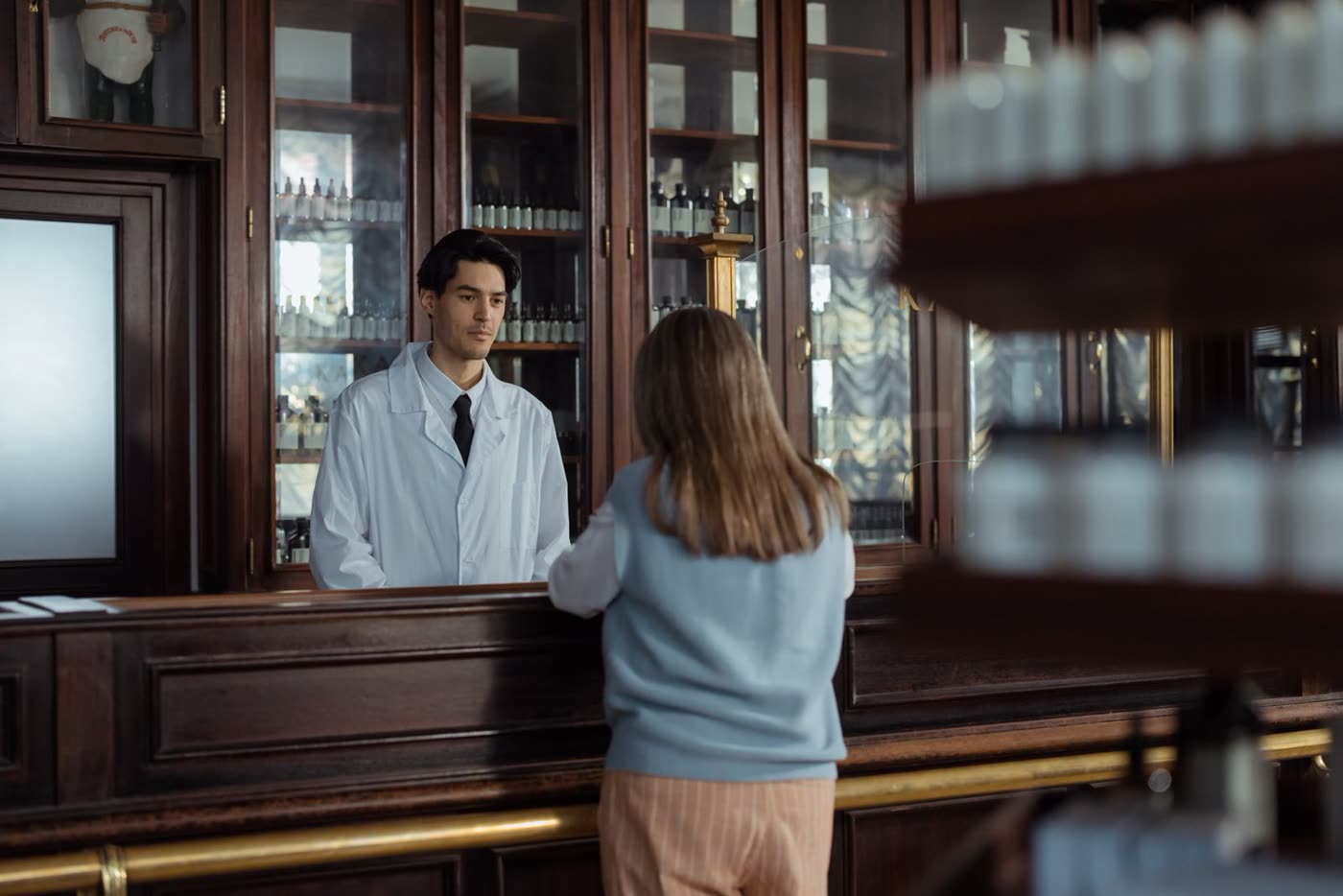 A pharmacist consulting with a customer